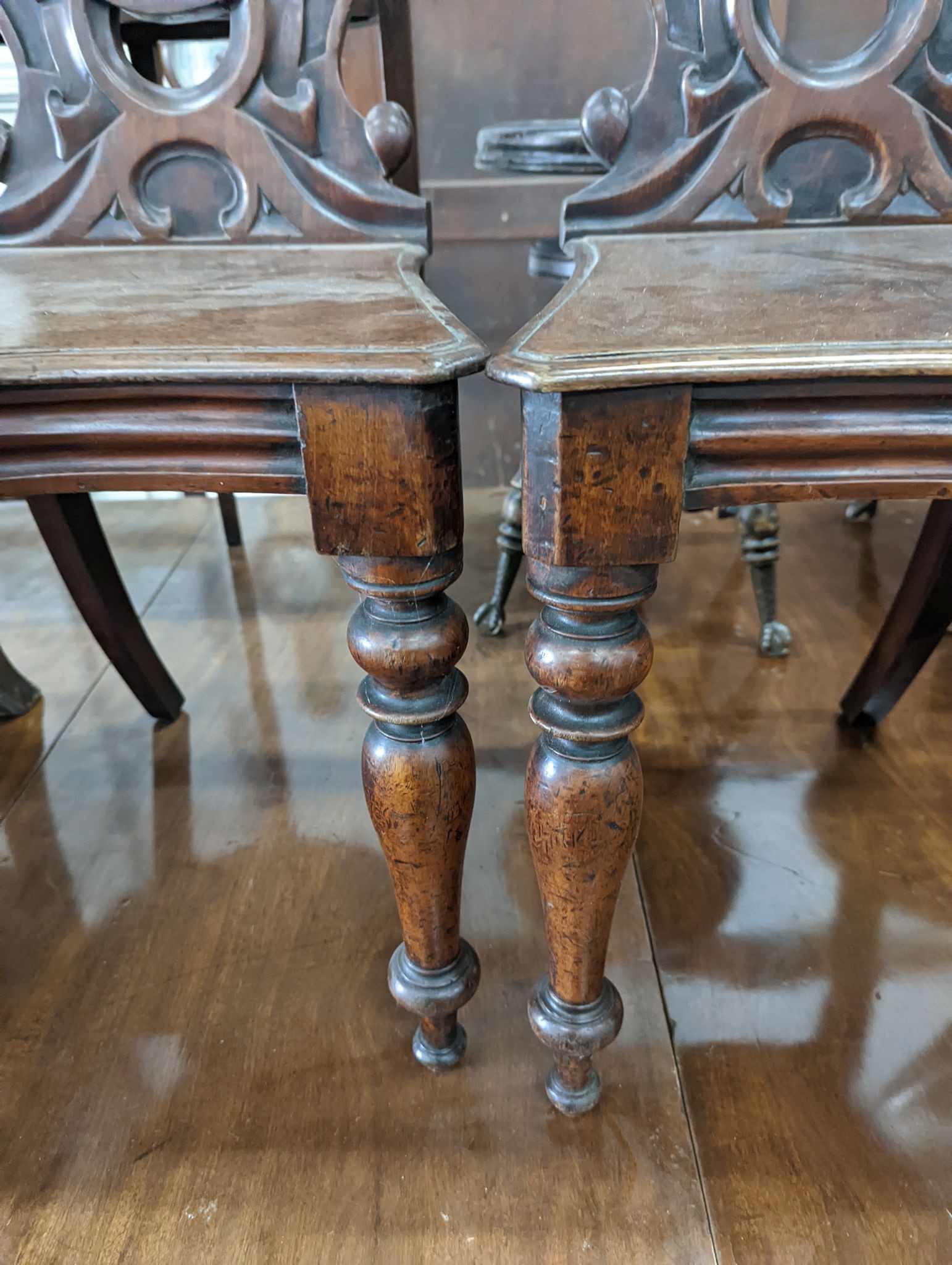 A pair of Victorian mahogany hall chairs and an oak hall chair
